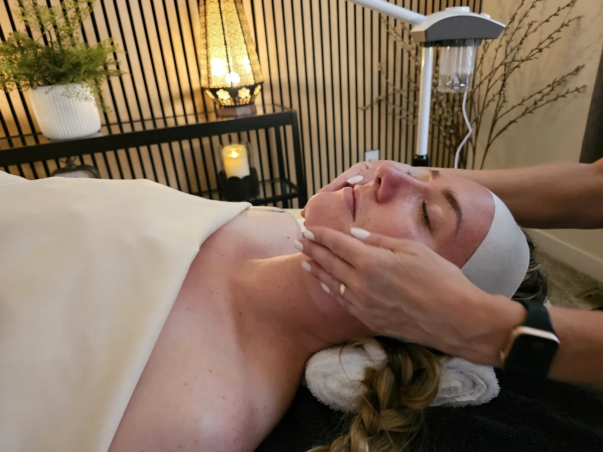 Esthetician performing facial massage during a signature facial at Ever Grace Skin Studio