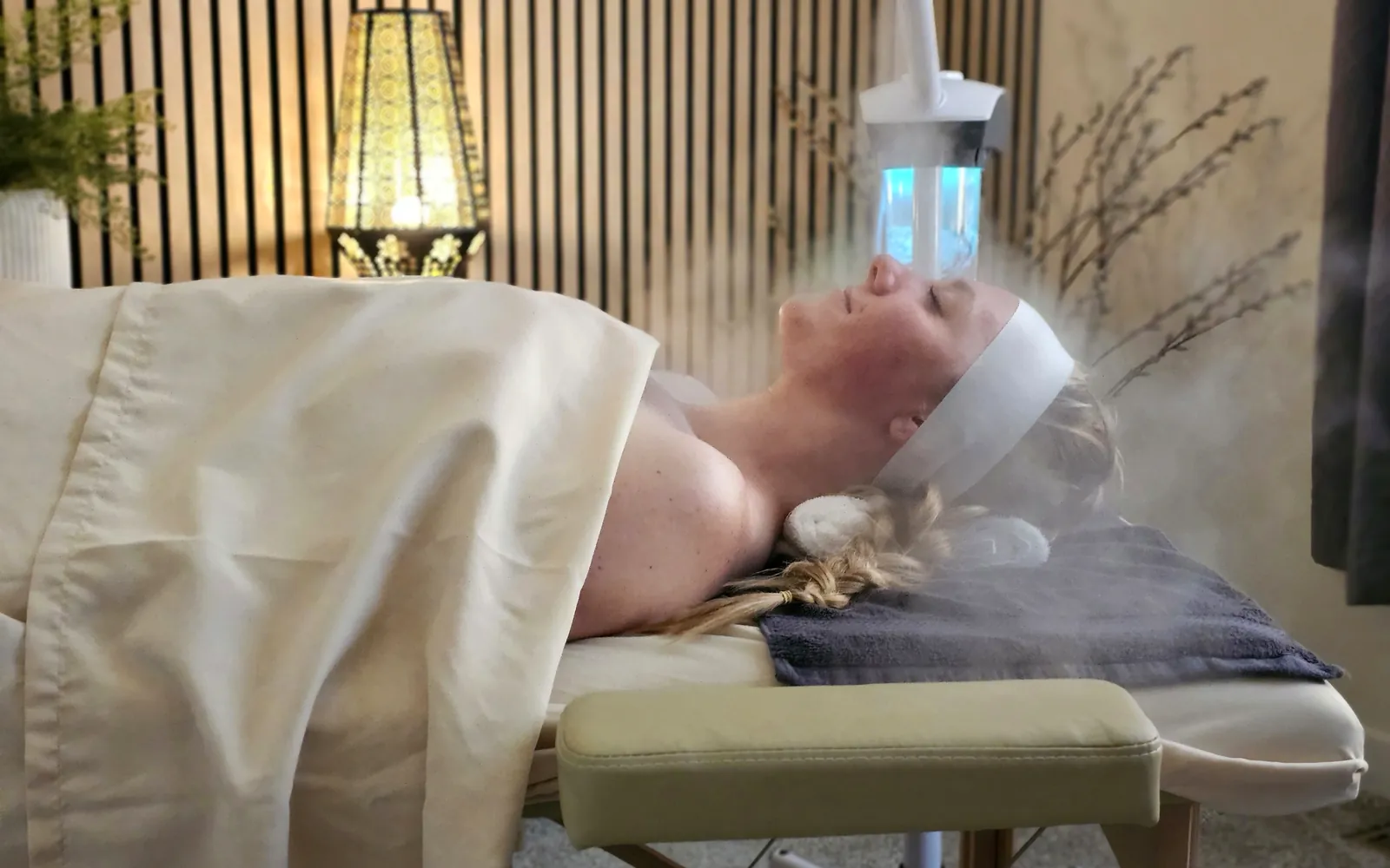Client relaxing under warm steam during a customized facial at Ever Grace Skin Studio in Thornton, CO